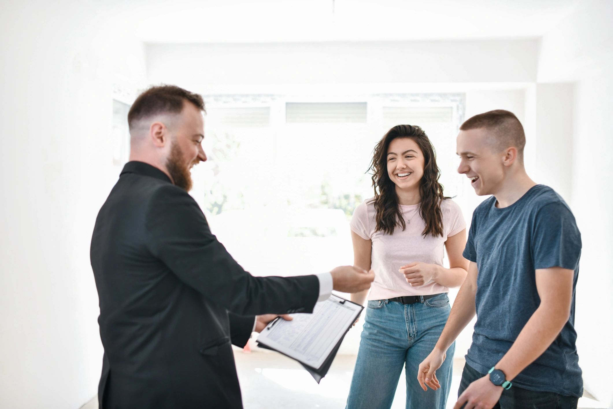 Smiling real estate agent with clients during a key handover