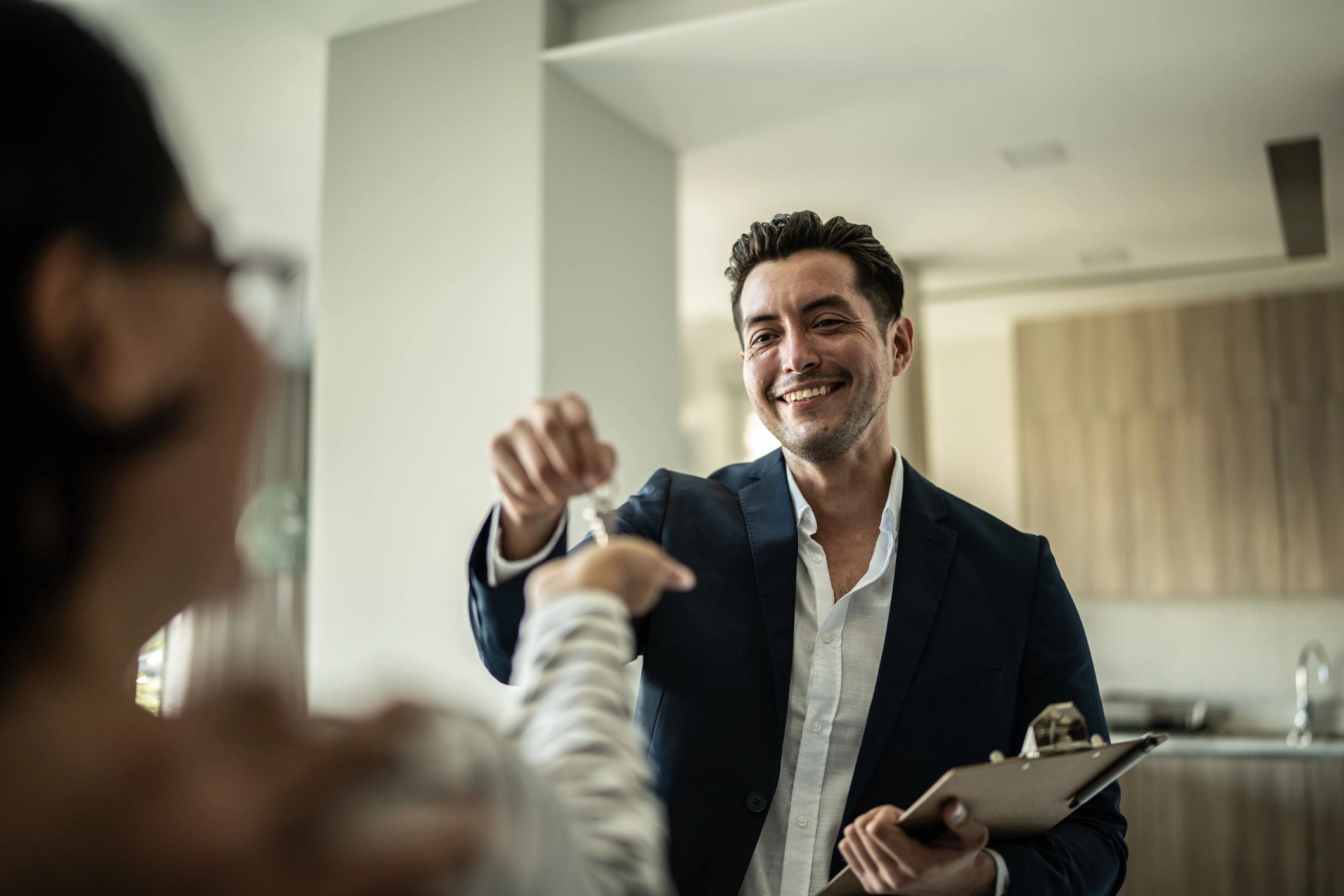 Real estate agent handing keys to a customer