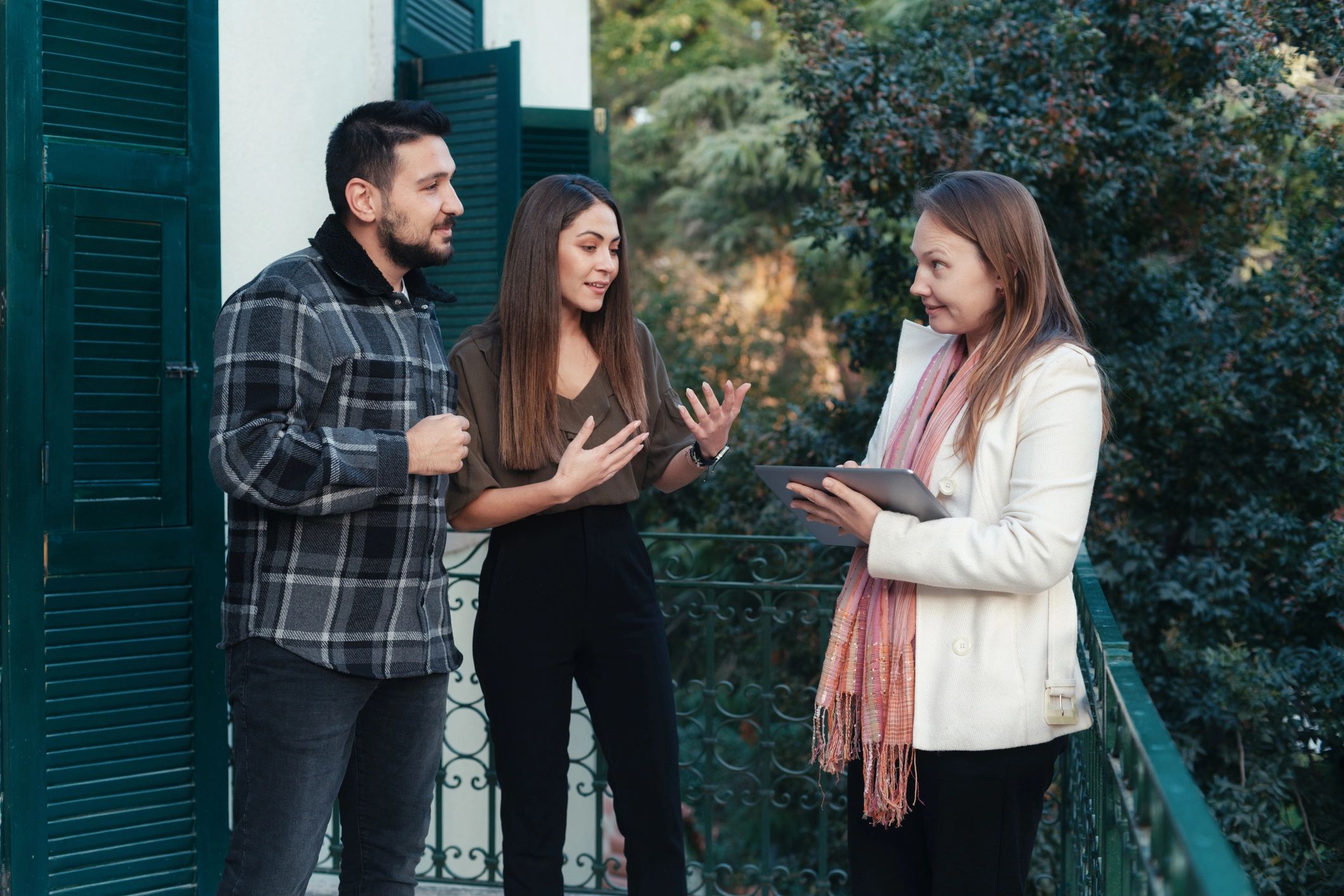 Real estate agent speaking with a couple in a home
